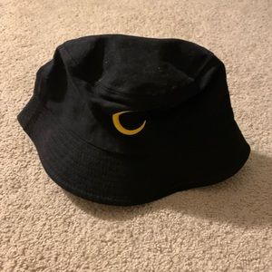 black bucket hat w yellow crescent moon.